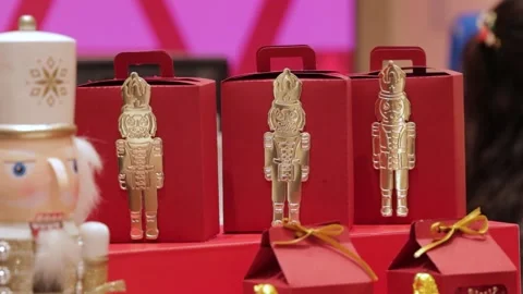 Nutcracker Christmas decorations on candy boxes, gold and red theme Stock Footage 286428253
