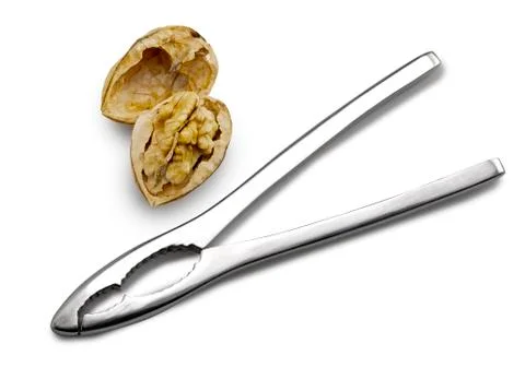 Nutcracker with closed and cracked walnuts on white background Stock Photos