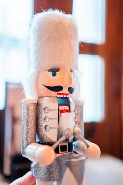 Nutcracker Doll With White Beard and Silver Coat Drumming the Drums Stock Photos