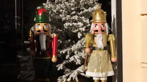 Nutcracker dolls in golden and red costumes standing behind the store window Stock-Footage 256617325