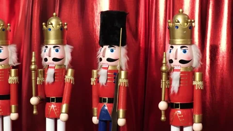 Nutcracker figures against a backdrop of scarlet fluttering fabric Stock Footage 297378429