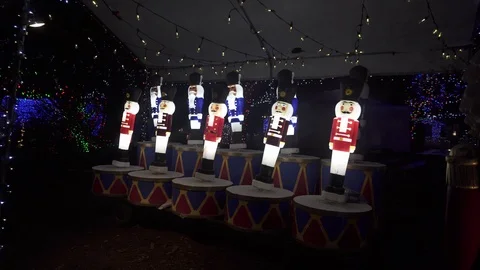 Nutcracker lamps sway side to side on drums in a Christmas display. Stock Footage 124357715