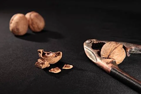 Nutcracker nutcracker, whole and chopped nuts on black background Copyrigh... Foto stock