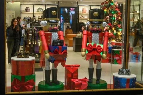 Nutcracker statues decorating a luxury brand store window at Christmas Stock Photos