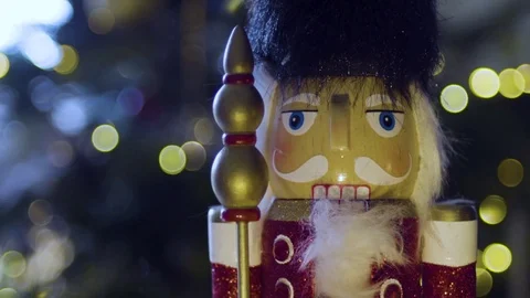 Nutcracker toy face in front of Christmas tree Stock Footage 82915293