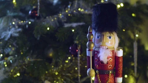 Nutcracker toy in front of Christmas tree Stock Footage 82915357