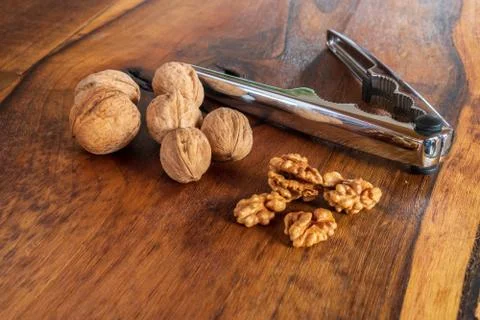 Nutcracker with walnuts on wooden background Foto stock