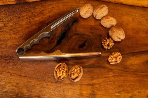 Nutcracker with walnuts on wooden background Stock Photos