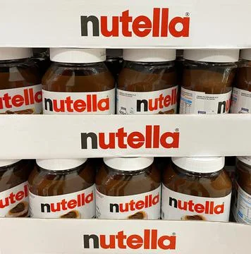 Nutella hazelnut spread jars in shelf of an italian supermarket. Stock Photos