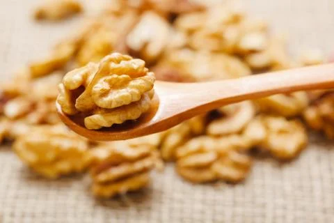 Nutmeat in spoon and in background Stock Photos