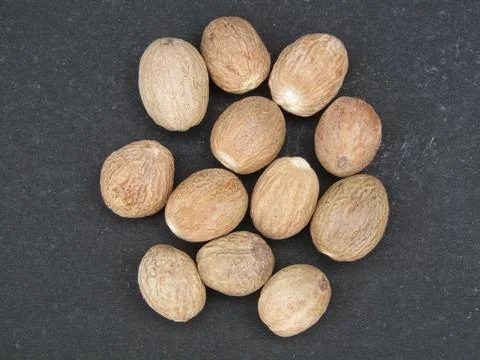 Nutmeg on black background close-up view Fotos de archivo