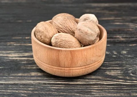 Nutmeg in bowl Stock Photos