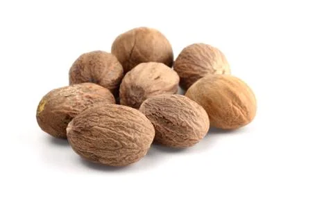 Nutmeg isolated on white background. Close up. Stock Photos