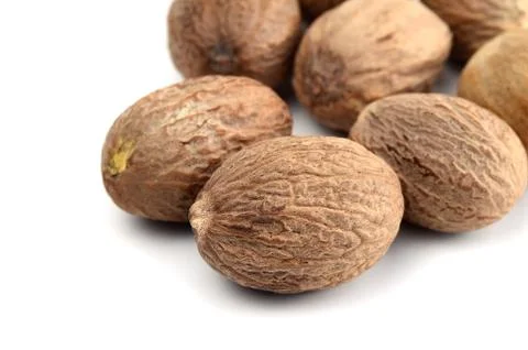 Nutmeg isolated on white background. Close up. Stock Photos