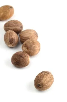 Nutmeg isolated on white background. Close up. Stock Photos