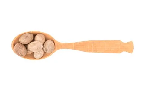 Nutmeg in spoon Stock Photos