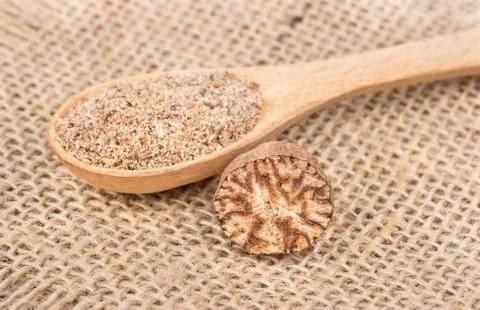 Nutmeg in spoon Stock Photos
