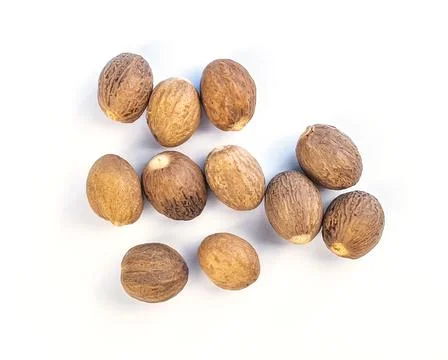 Nutmeg on a white table Stock Photos