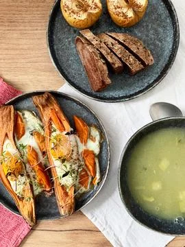 Nutrient-rich eggs baked inside sweet potatoes sit on a rustic plate. Fresh.. Stock Photos
