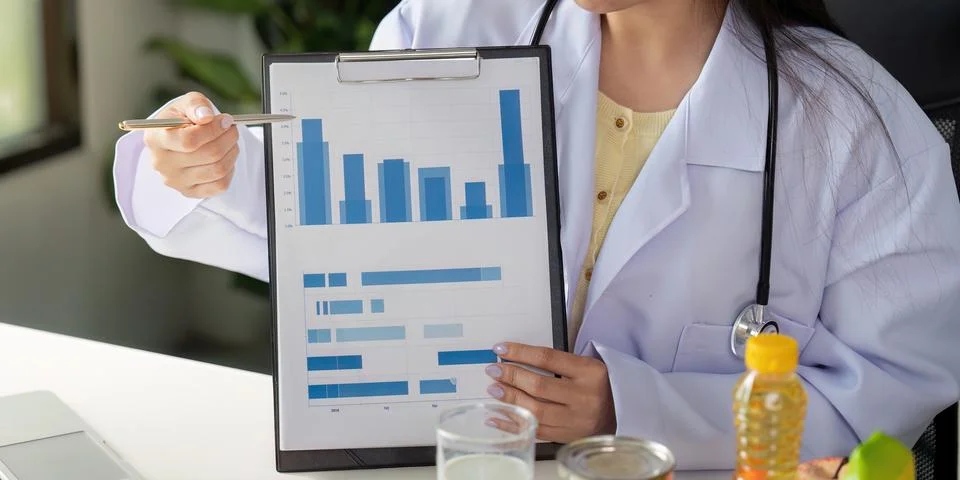 Nutrition analysis. A dietitian explaining data on food consumption during a Stock Photos
