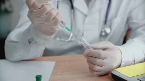 A nutritional scientist conducts experiments by synthesizing compounds with Stock Footage 154162787