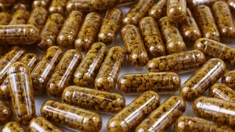 Nutritional supplement capsules with bee pollen inside circle rotation Stock Footage 233998367