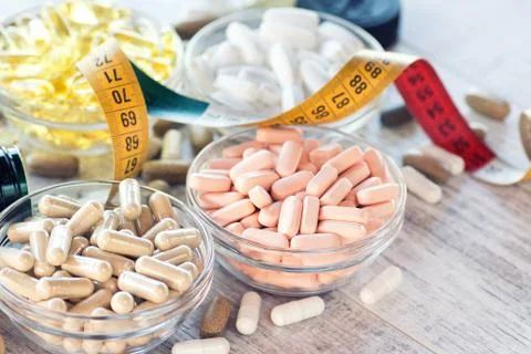 Nutritional supplements in capsules and tablets. Selective focus, shallow DOF Stock Photos