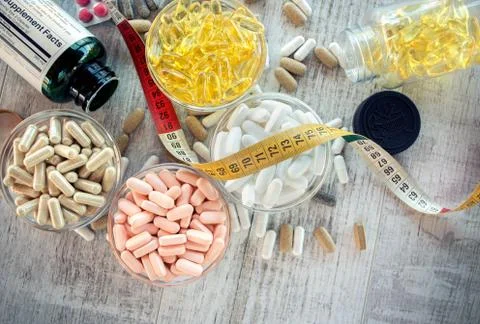 Nutritional supplements in capsules and tablets. Selective focus, shallow DOF Stock Photos