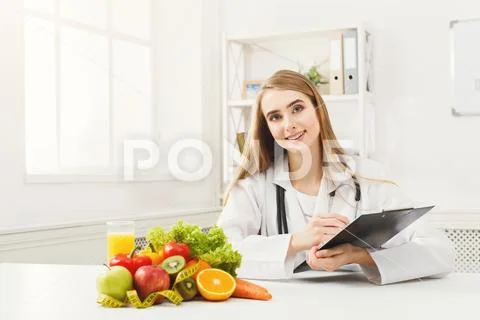 Nutritionist desk with fruit and measuring tape Stock Photos