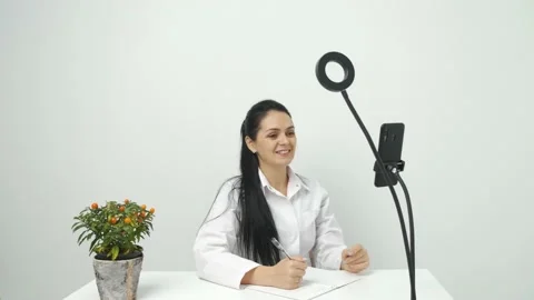 Nutritionist talking on video chat using mobile phone at work, online Stock Footage 149592452
