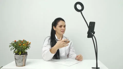 Nutritionist talking on video chat using mobile phone at work, online Stock Footage 150061861