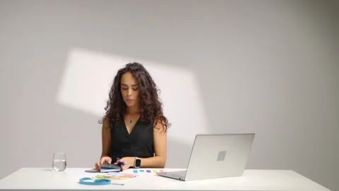 Nutritionist Writing Notes at Desk While Using Laptop in Professional Studio Stock Footage 337708762
