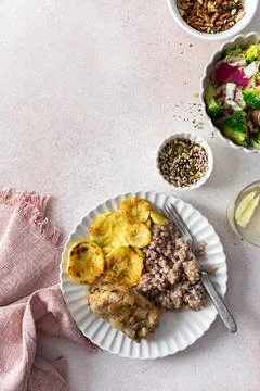 A nutritious, balanced breakfast featuring green buckwheat, fried hake, zuc.. Stock Photos