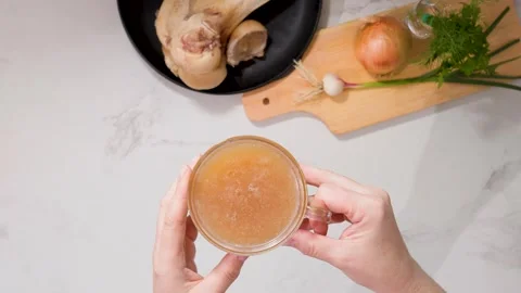 Nutritious bone broth beverage in glass highlights health, hydration, and Stock Footage 344031533