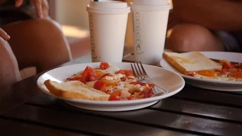 A nutritious breakfast of scrambled eggs with tomatoes and toast, with Stock Footage 90420713
