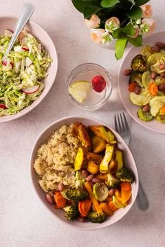 A nutritious breakfast spread includes quinoa, baked sweet potatoes, carrots, Stock Photos