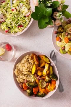 A nutritious breakfast spread includes quinoa, baked sweet potatoes, carrots, Stock Photos