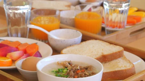 Nutritious breakfast spread with porridge, bread slices, fruit, and Stockbeeldmateriaal 291703391