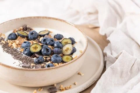 A nutritious breakfast yogurt bowl filled with fresh blueberries, crunchy g.. Stock Photos