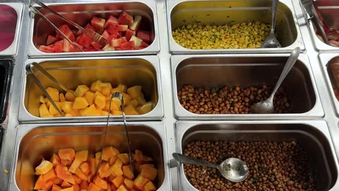 Nutritious buffet selection with watermelon papaya corn peanuts and chickpeas Stock Footage 337966745