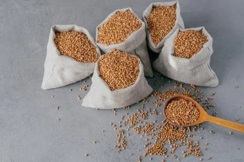 Nutritious ingredient containing vitamins. Shot of linen sacks with buckwheat Foto stock