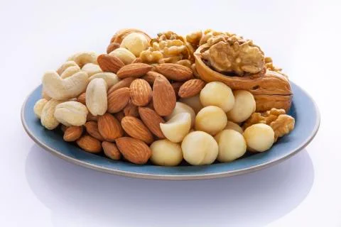 Nutritious, mixed nuts, walnuts, almonds, cashews, macadamia nuts Stock Photos