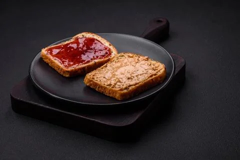 Nutritious sandwiches consisting of bread, raspberry jam and peanut butter Stock Photos