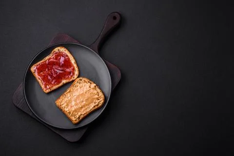 Nutritious sandwiches consisting of bread, raspberry jam and peanut butter Stock Photos