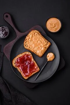 Nutritious sandwiches consisting of bread, raspberry jam and peanut butter Stock Photos