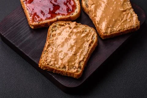 Nutritious sandwiches consisting of bread, raspberry jam and peanut butter Stock Photos