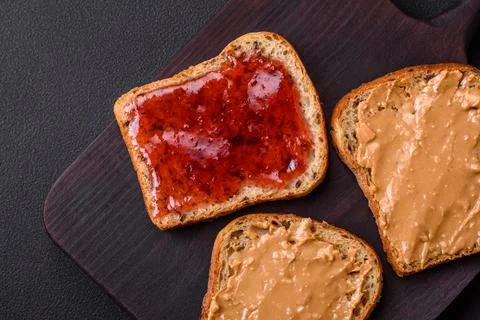 Nutritious sandwiches consisting of bread, raspberry jam and peanut butter Stock Photos