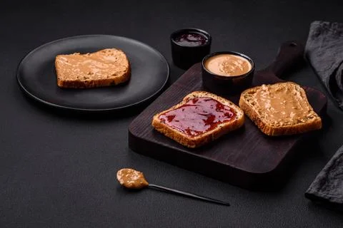 Nutritious sandwiches consisting of bread, raspberry jam and peanut butter Stock Photos