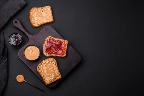 Nutritious sandwiches consisting of bread, raspberry jam and peanut butter Stock Photos