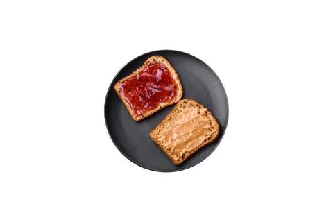Nutritious sandwiches consisting of bread, raspberry jam and peanut butter... Stock Photos